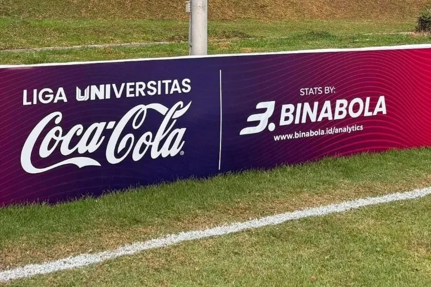 A Liga Universitas Coca-Cola banner beside the pitch, with Stats by BinaBola and binabola.id/analytics.